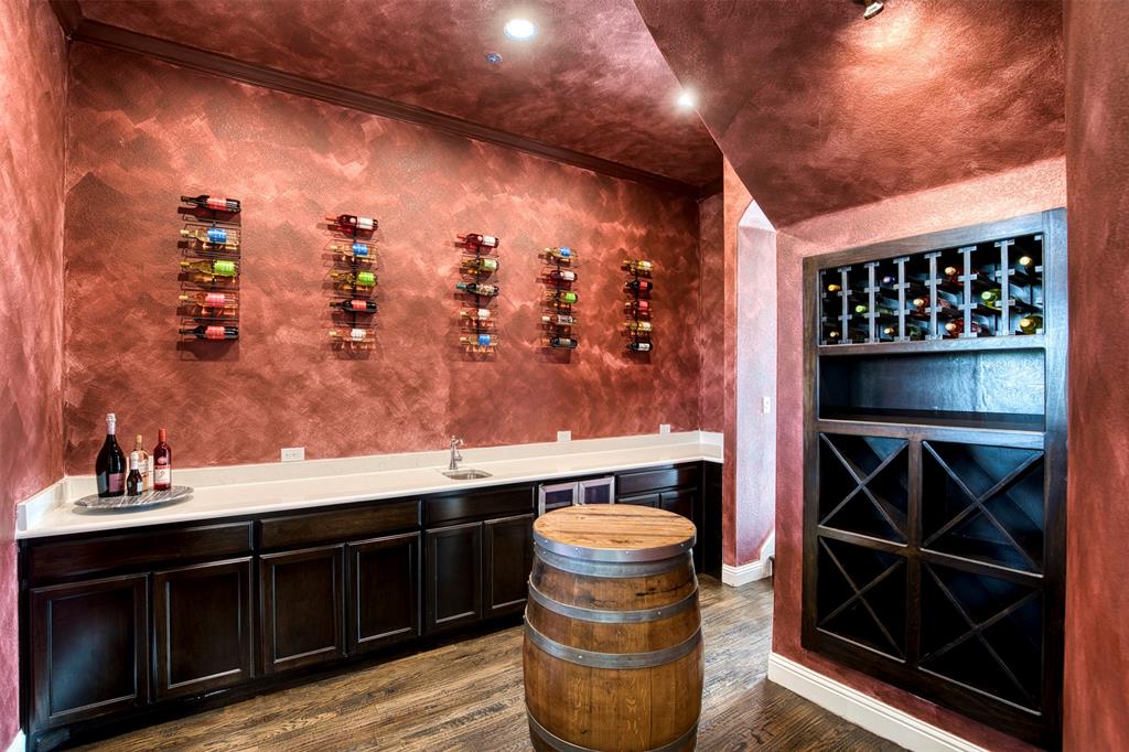 901 Inverness Court Lucas, TX 75002 - Photo 8 of 40 Wine cellar with wet bar, dark wood-style floors, and ornamental molding