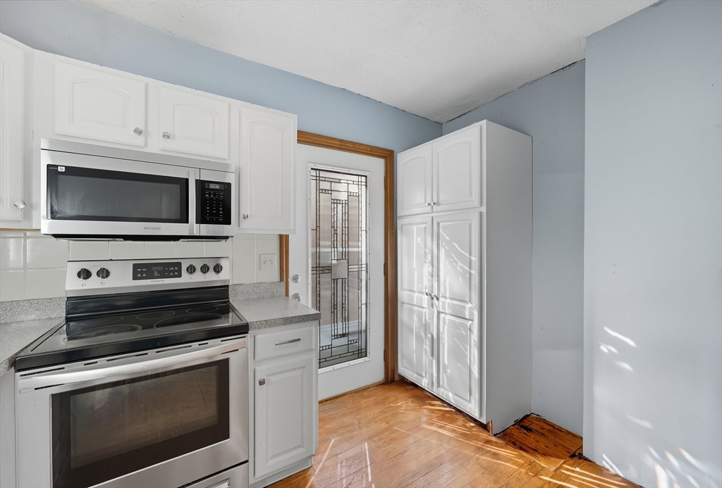72 Highland Avenue Ludlow, MA 01056 - Photo 18 of 32 a kitchen with a stove and a microwave