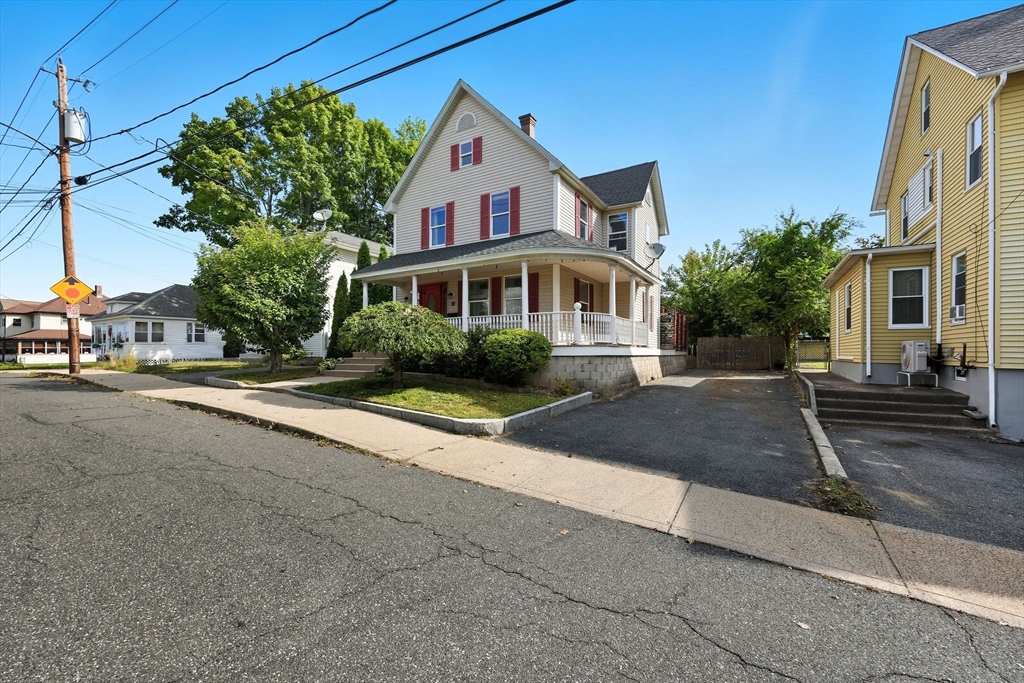 72 Highland Avenue Ludlow, MA 01056 - Photo 2 of 32 a front view of a house with a yard and trees