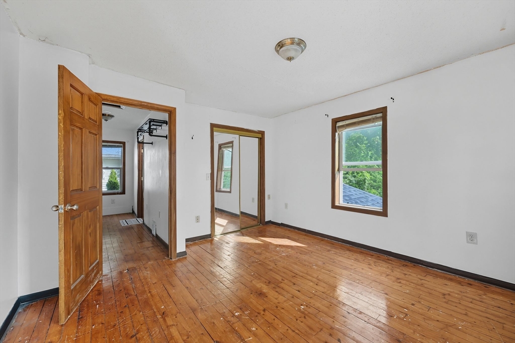 72 Highland Avenue Ludlow, MA 01056 - Photo 27 of 32 a view of an empty room with window and wooden floor