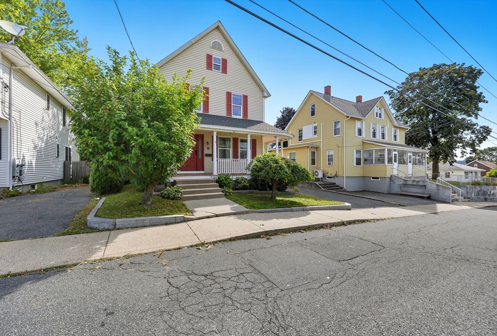 72 Highland Avenue Ludlow, MA 01056 - Photo 4 of 32 a front view of a house with a yard and a garage