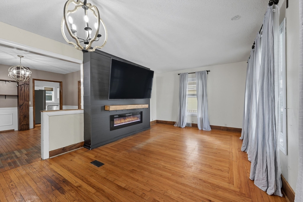 72 Highland Avenue Ludlow, MA 01056 - Photo 8 of 32 wooden floor in an empty room with a fireplace