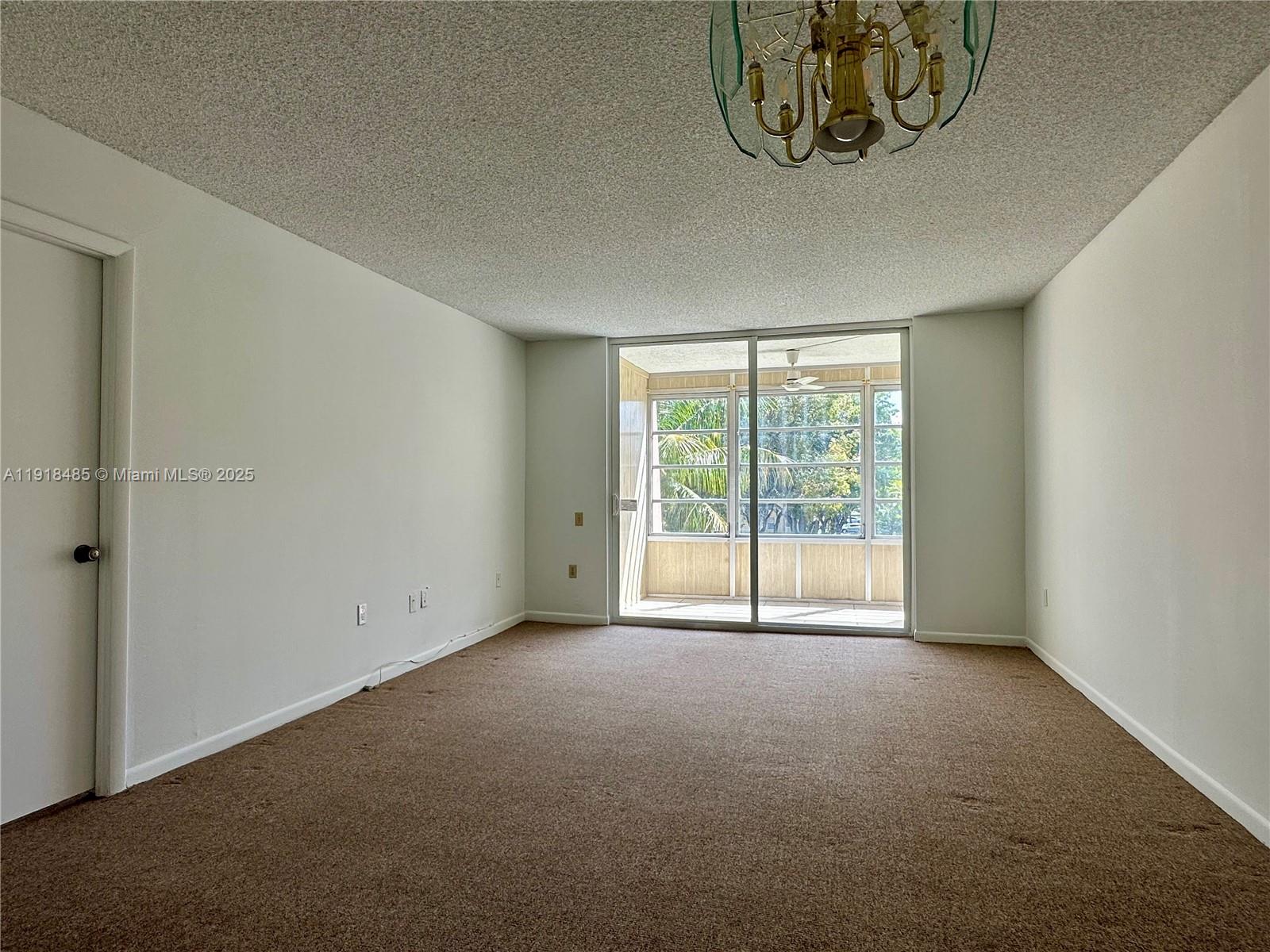 9101 Lime Bay Boulevard, Unit 302 Tamarac, FL 33321 - Photo 11 of 34 a view of an empty room with a window