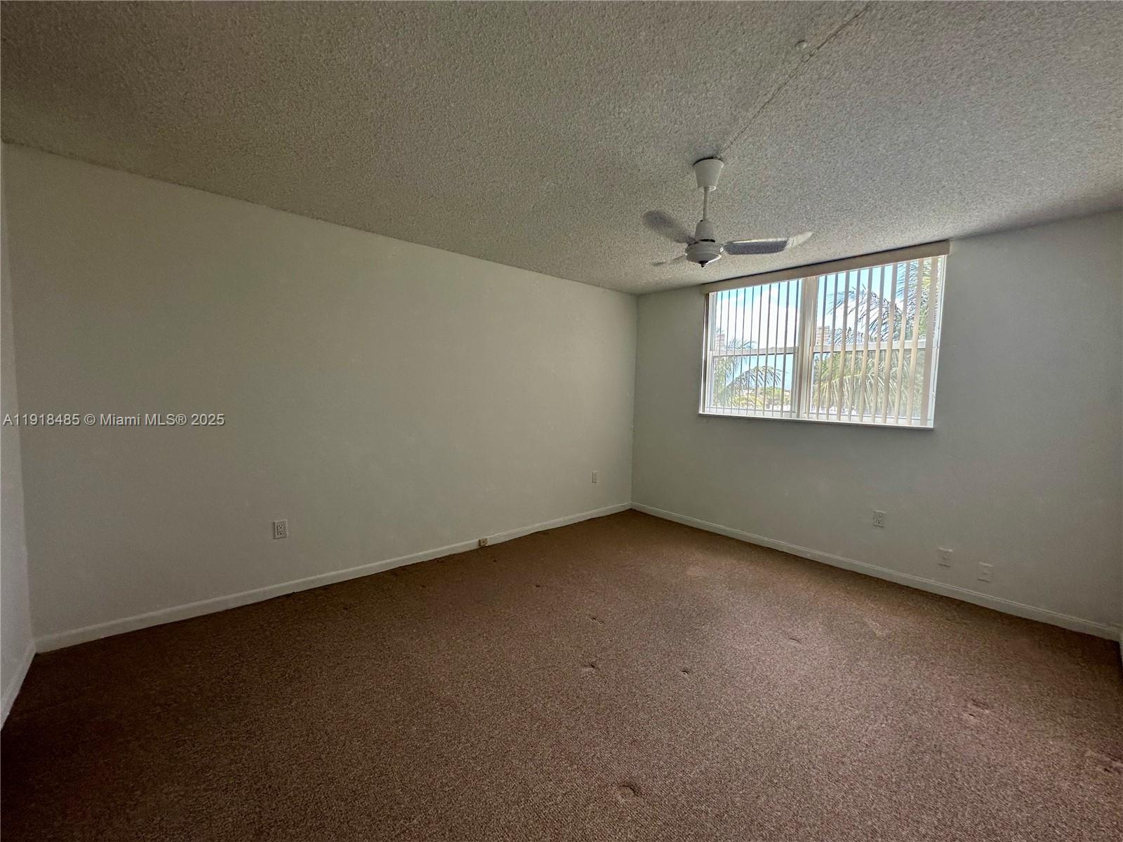 9101 Lime Bay Boulevard, Unit 302 Tamarac, FL 33321 - Photo 16 of 34 an empty room with a window
