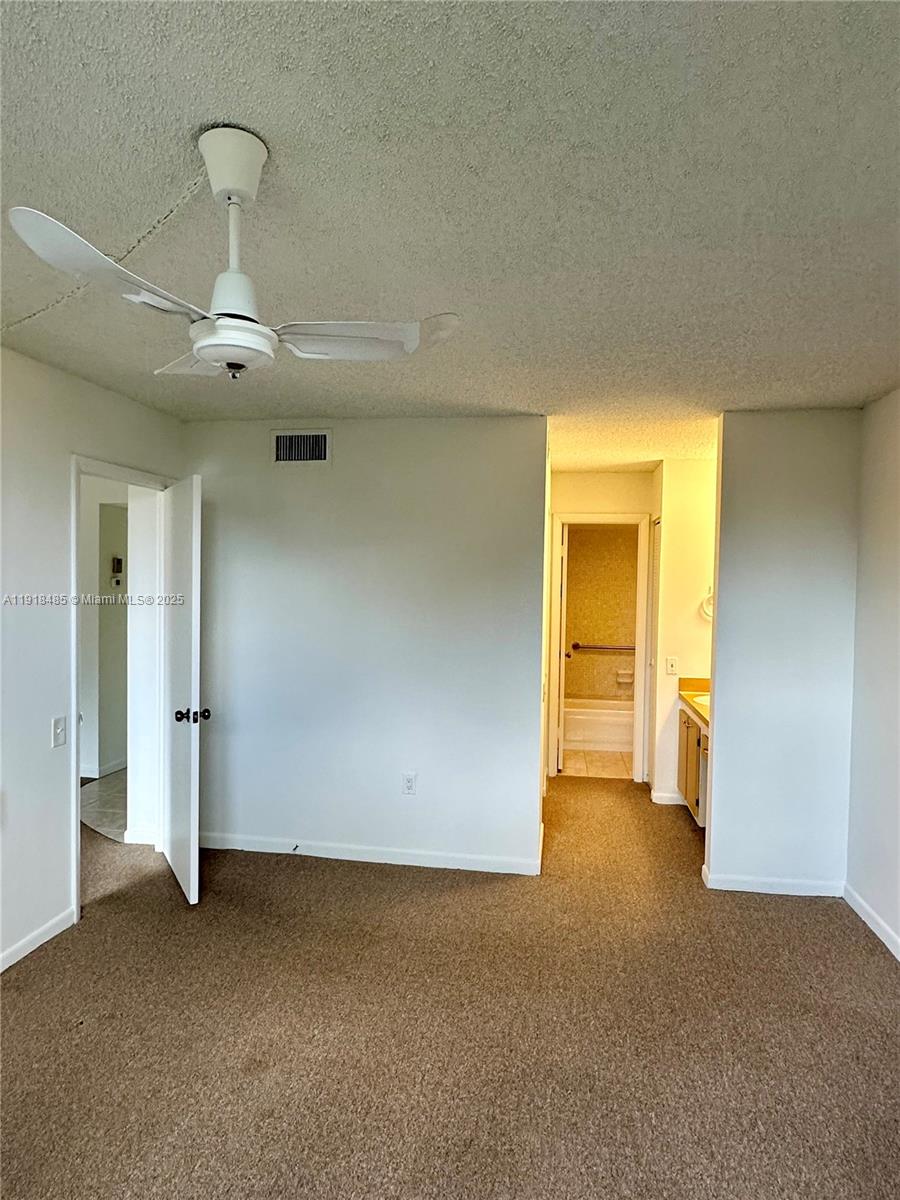 9101 Lime Bay Boulevard, Unit 302 Tamarac, FL 33321 - Photo 19 of 34 a view of an empty room and glass door