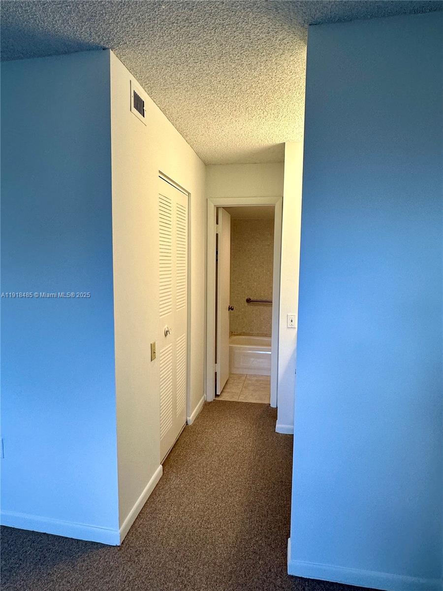 9101 Lime Bay Boulevard, Unit 302 Tamarac, FL 33321 - Photo 20 of 34 a view of a hallway with closet