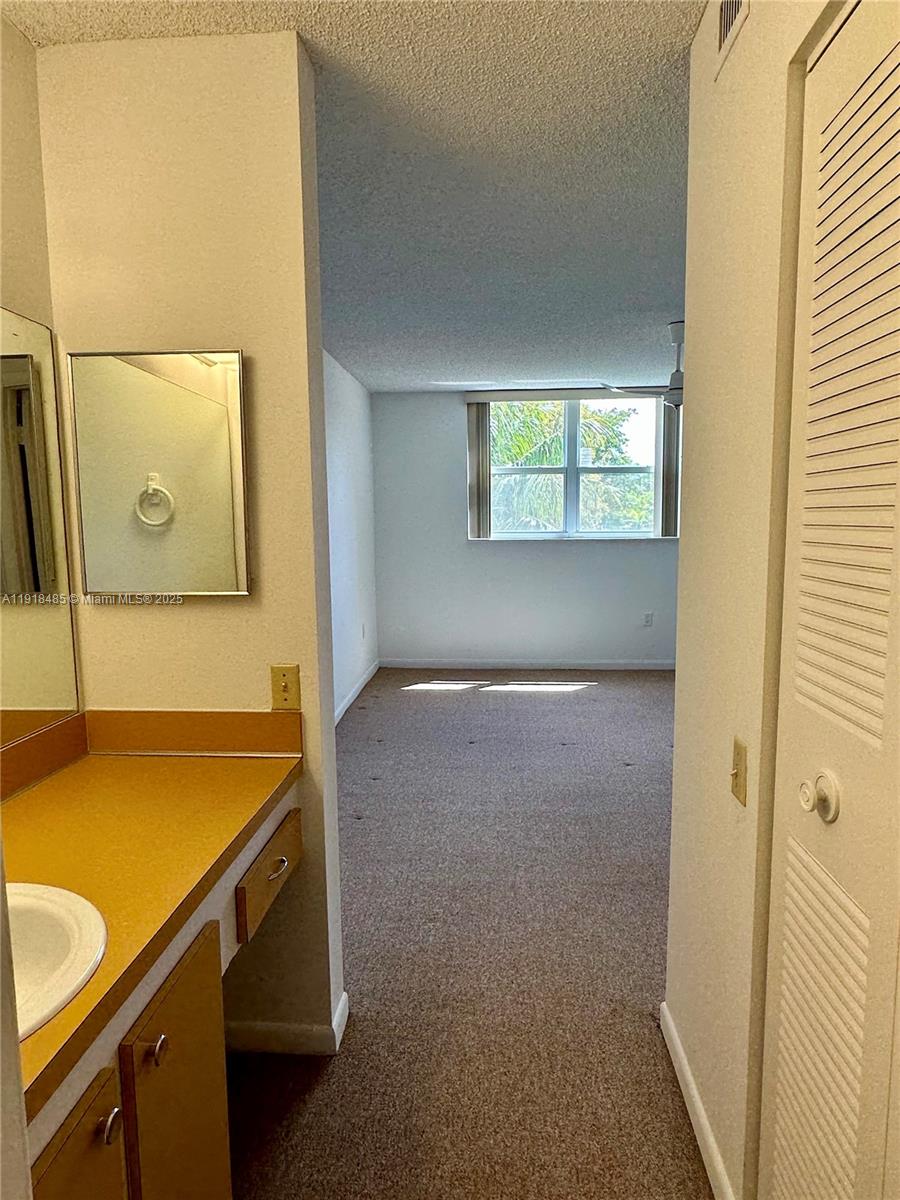 9101 Lime Bay Boulevard, Unit 302 Tamarac, FL 33321 - Photo 22 of 34 a room with a wooden floor and a table