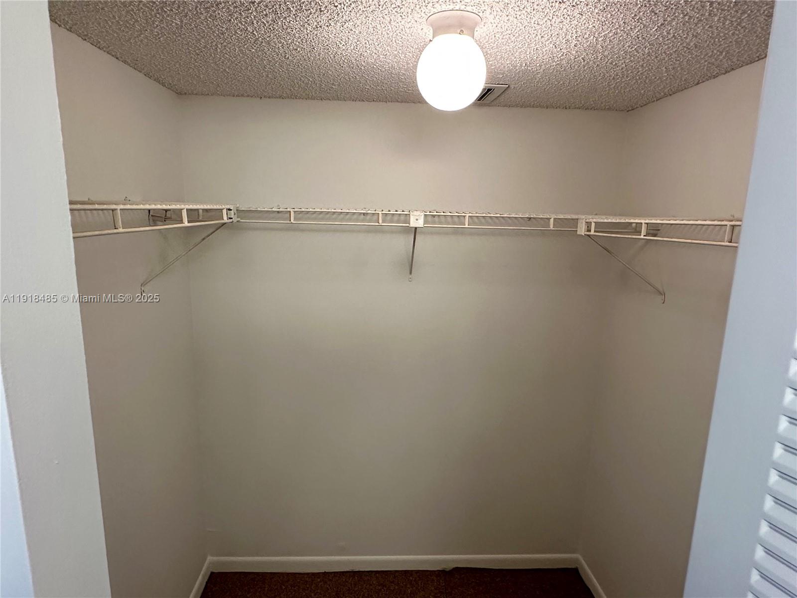 9101 Lime Bay Boulevard, Unit 302 Tamarac, FL 33321 - Photo 25 of 34 a view of small space with racks on the wall