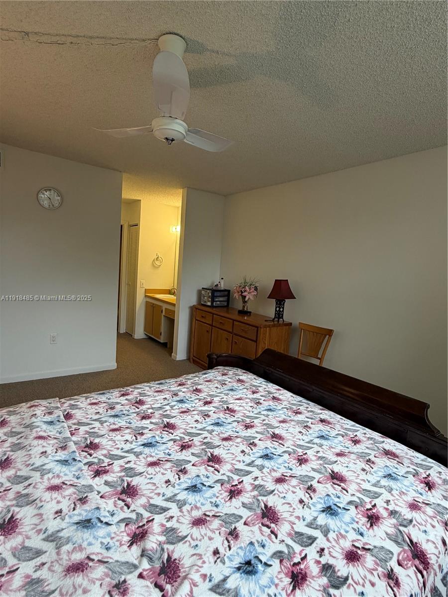 9101 Lime Bay Boulevard, Unit 302 Tamarac, FL 33321 - Photo 31 of 34 a bed room with a bed