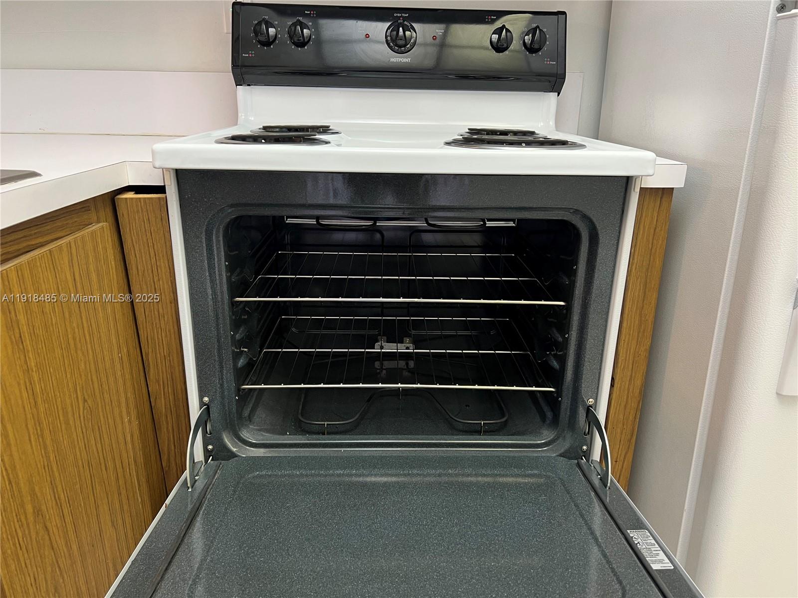 9101 Lime Bay Boulevard, Unit 302 Tamarac, FL 33321 - Photo 6 of 34 a stove top oven sitting inside of a kitchen