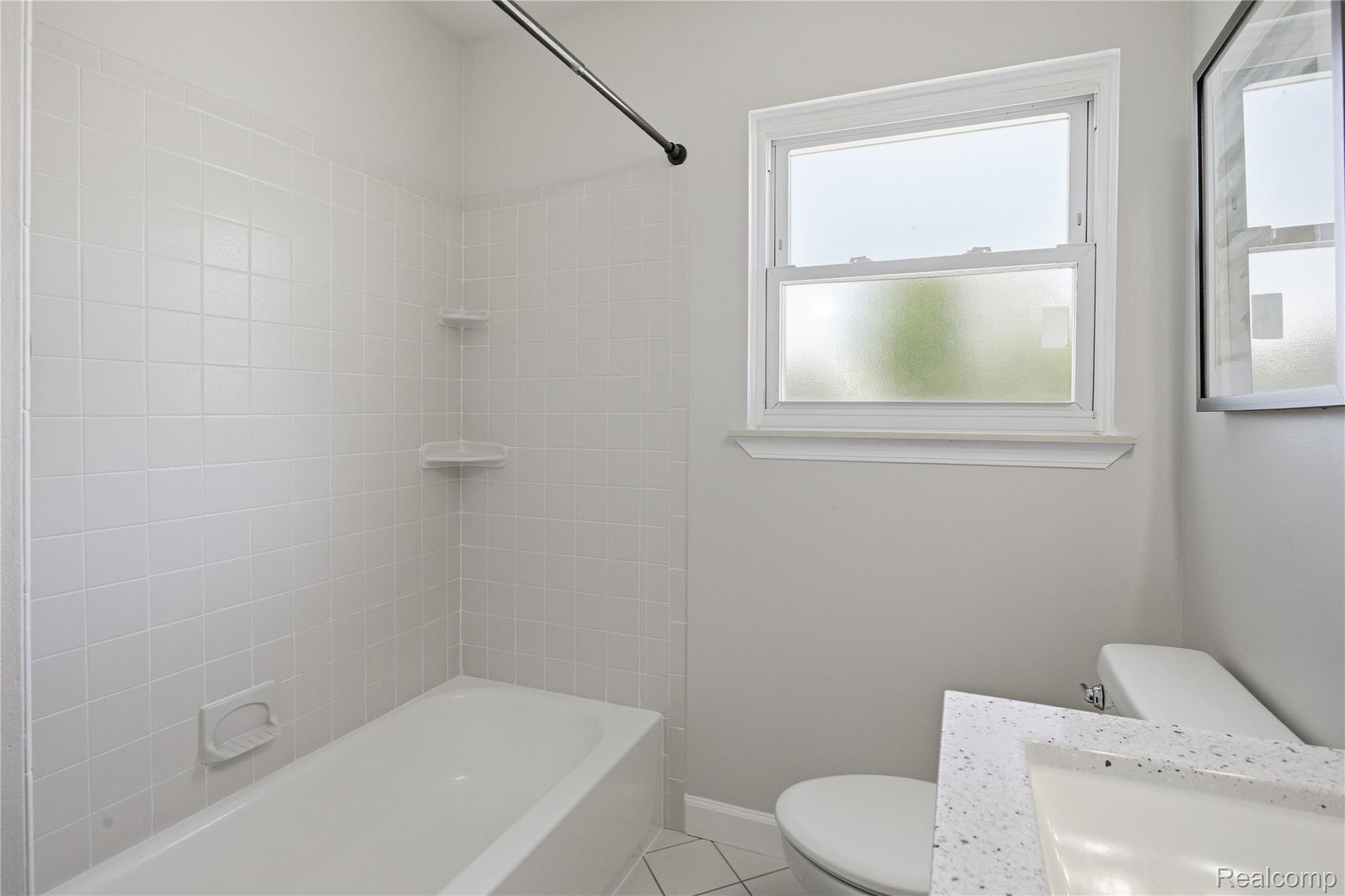 37257 Dundee Street Sterling Heights, MI 48310 - Photo 23 of 47 Bathtub and shower combination with white square tile surround