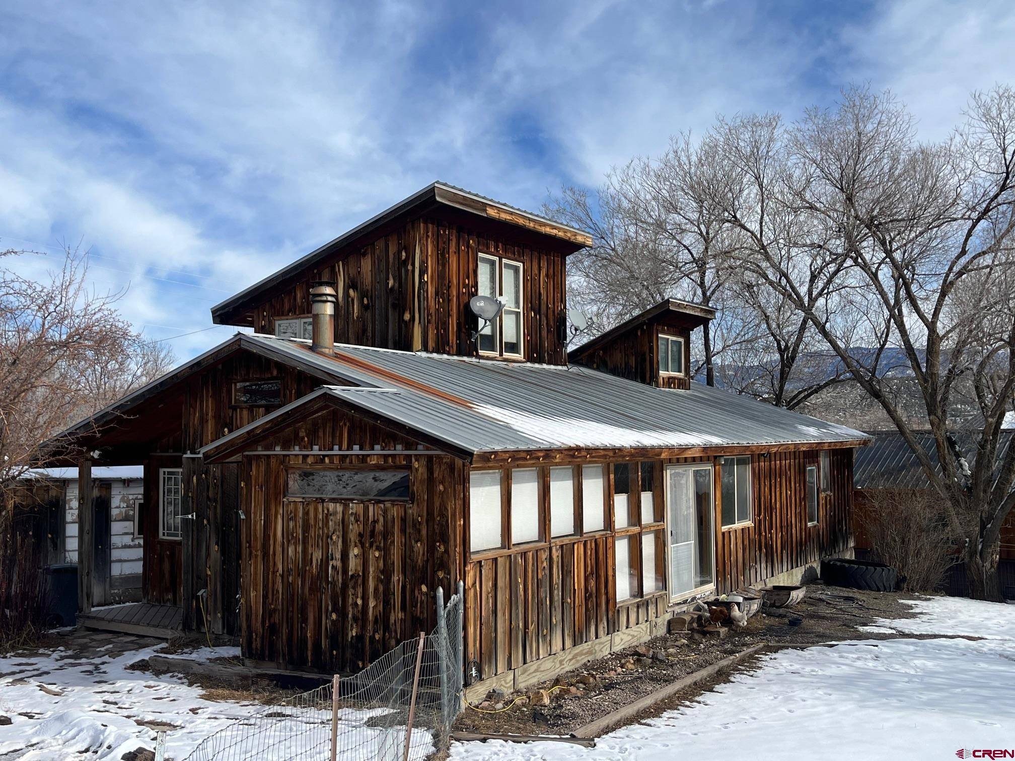 214 North Amelia Street Ridgway, CO 81432 - Photo 2 of 18 a front view of a house with a yard