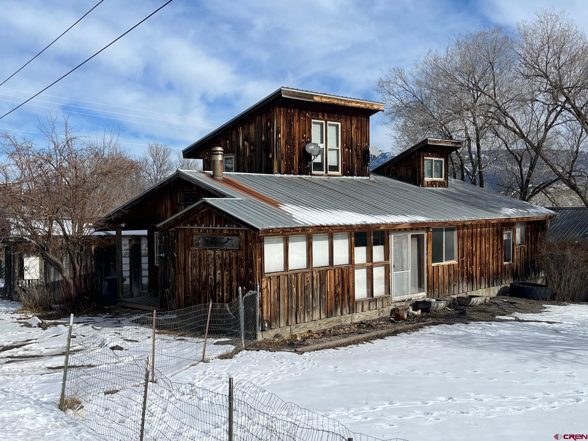 214 North Amelia Street Ridgway, CO 81432 - Photo 3 of 18 a front view of a house with a yard