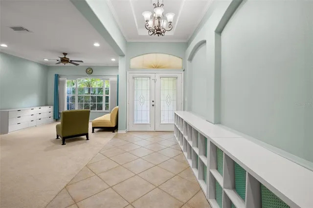 a large kitchen with a stove a sink a counter top space and cabinets