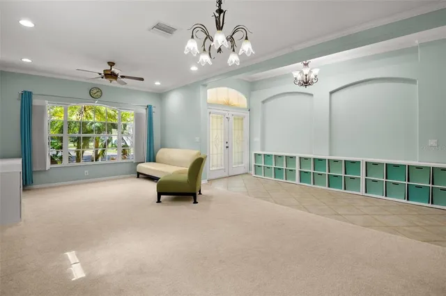 a living room with furniture and a ceiling fan