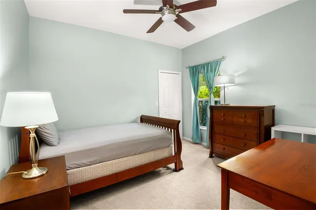 an aerial view of residential houses with outdoor space and trees