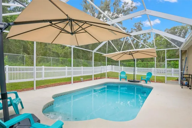 a view of a hallway with wooden floor and windows