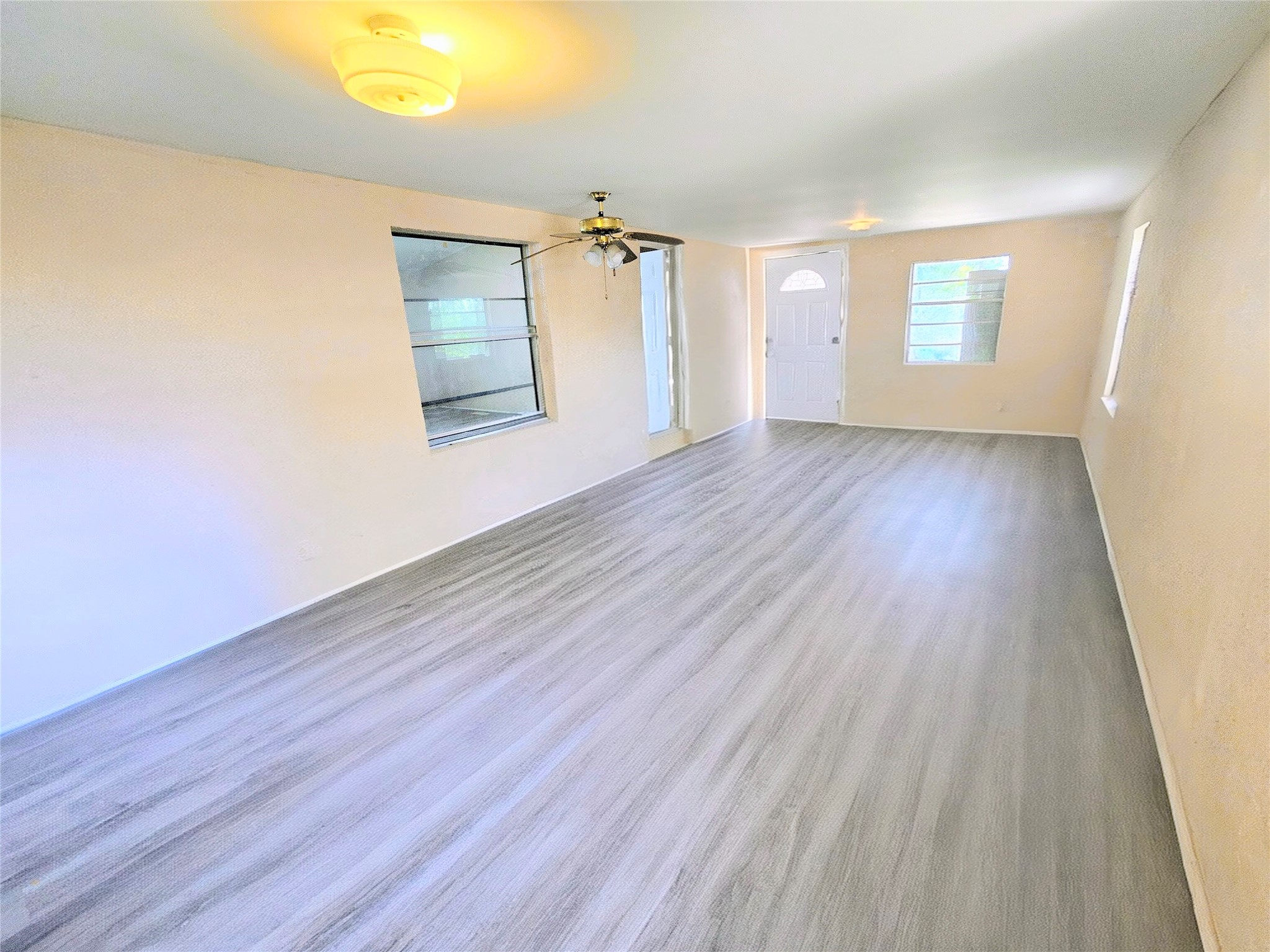 142 Aspen Livingston, TX 77351 - Photo 5 of 17 an empty room with wooden floor and windows
