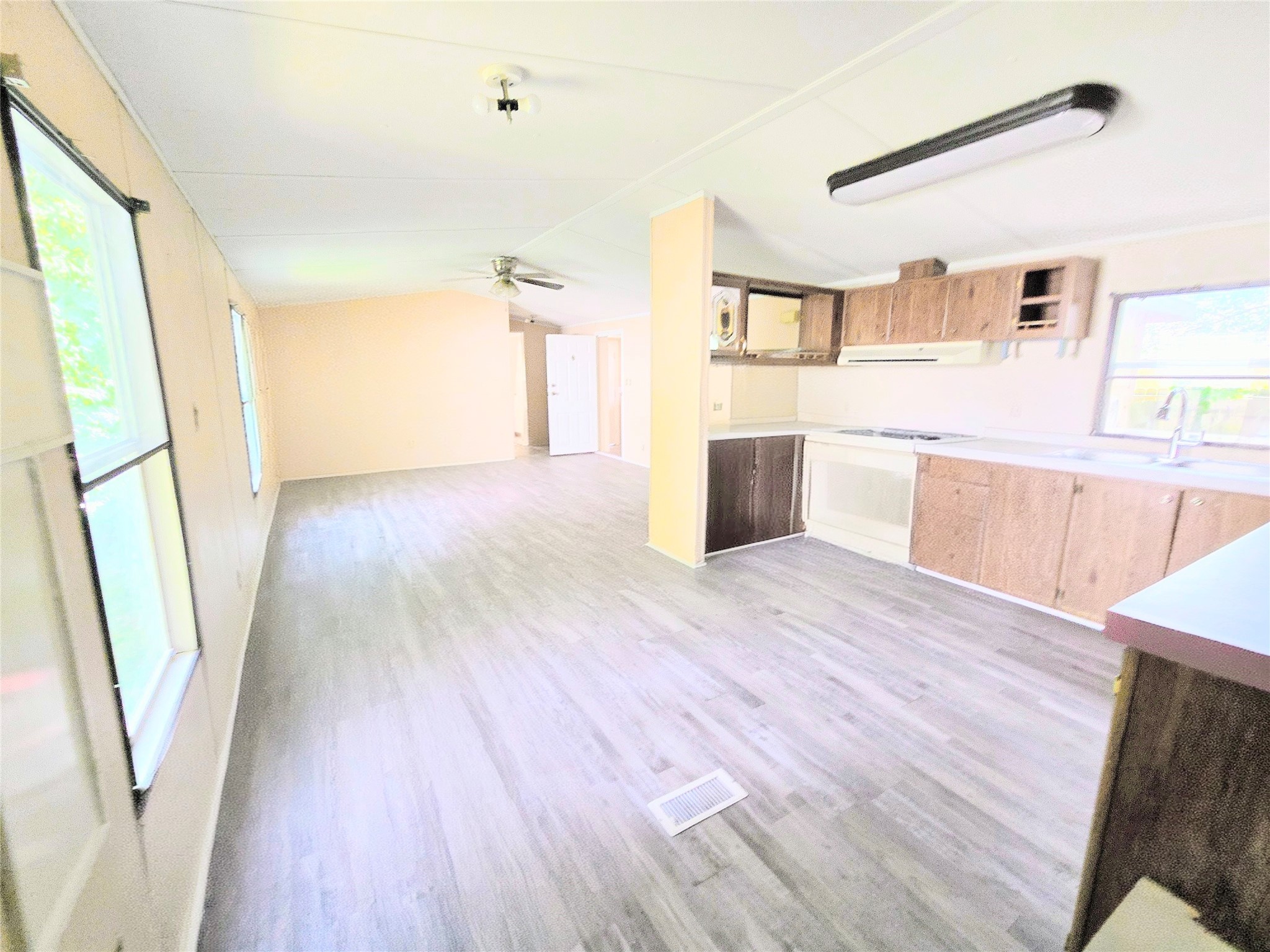 142 Aspen Livingston, TX 77351 - Photo 7 of 17 a view of a kitchen with wooden floors and wooden cabinets