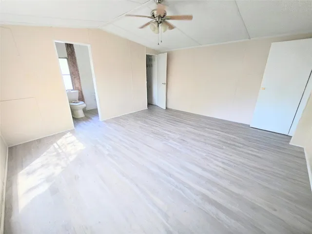 a view of a room with wooden floor and white walls