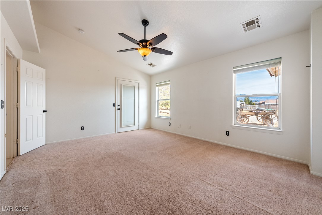 3581 Ranger Way Pahrump, NV 89048 - Photo 30 of 57 Primary Room with lofted ceiling, a ceiling fan, visible vents, and light colored carpet