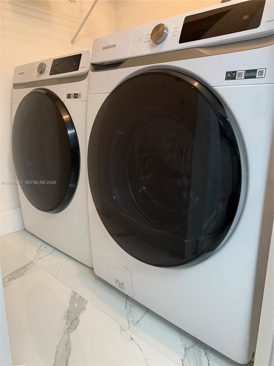 9273 Collins Avenue, Unit 606 Surfside, FL 33154 - Photo 24 of 25 a utility room with dryer and washer