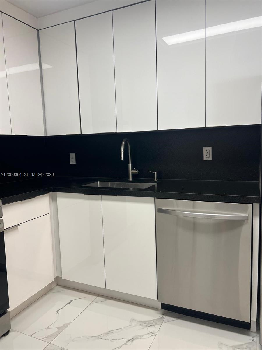 9273 Collins Avenue, Unit 606 Surfside, FL 33154 - Photo 5 of 25 a view of cabinets