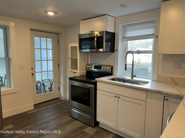 a kitchen with stainless steel appliances granite countertop a stove and a microwave