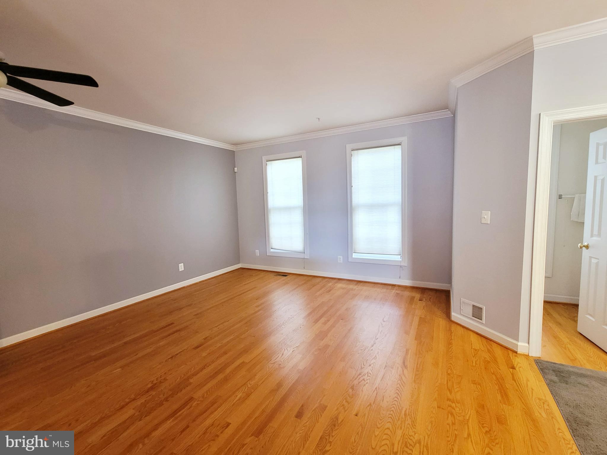 3960 Addison Woods Road Frederick, MD 21704 - Photo 13 of 19 an empty room with wooden floor and windows