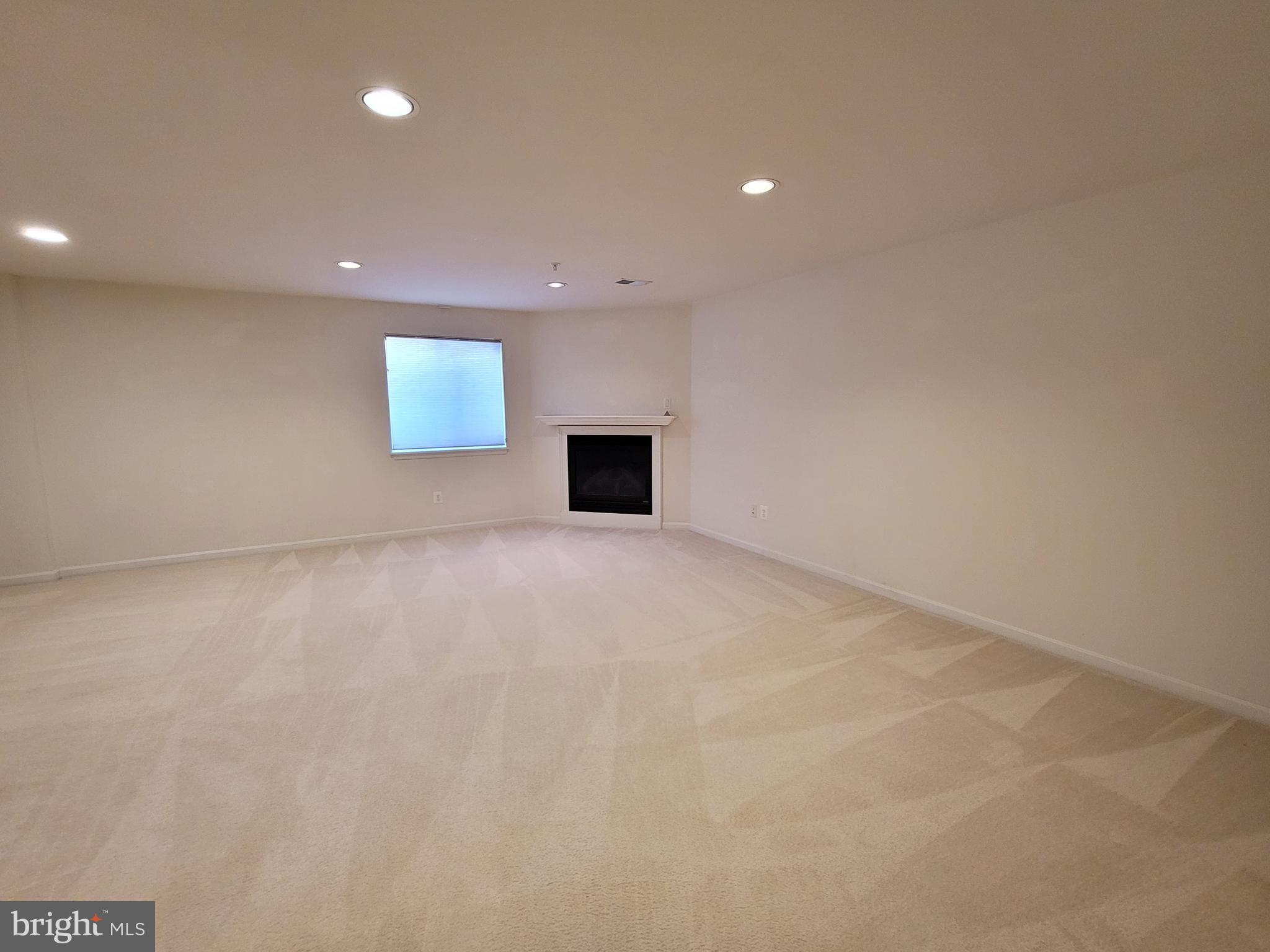 3960 Addison Woods Road Frederick, MD 21704 - Photo 19 of 19 an empty room with windows and fireplace