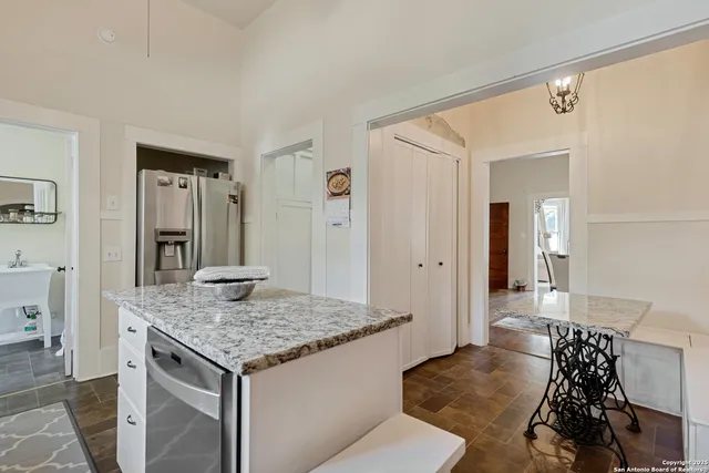 a view of kitchen island with granite countertop living room
