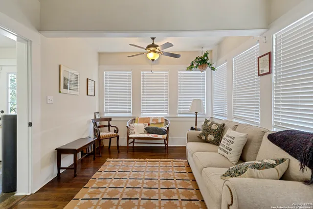 a living room with furniture and wooden floor