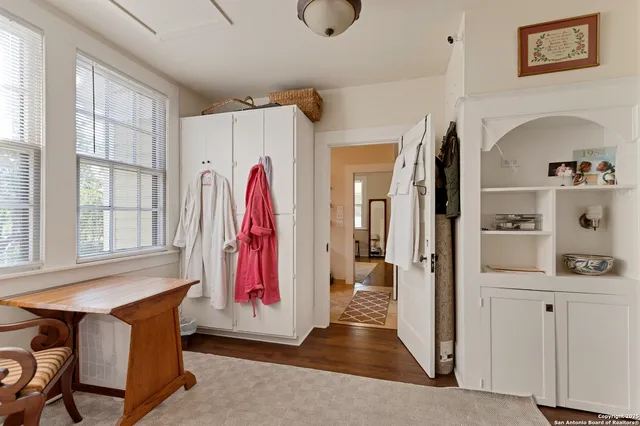 a view of a bedroom with furniture and window