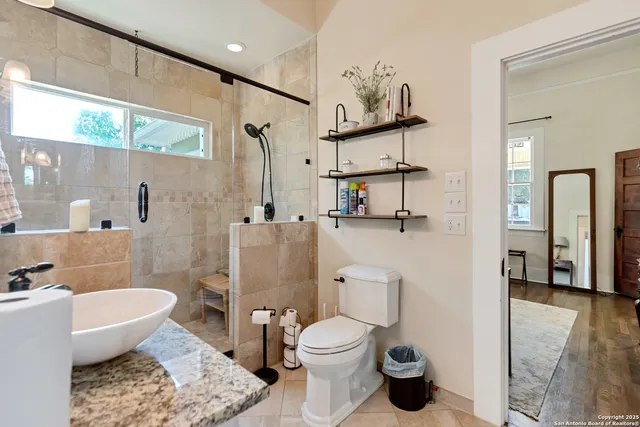 a bathroom with a toilet sink and shower