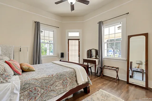 a bedroom with a bed and a chandelier next to a window