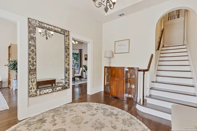 a view of an entryway with wooden floor and a livingroom view
