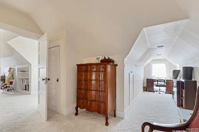 a view of a livingroom with furniture and an empty room