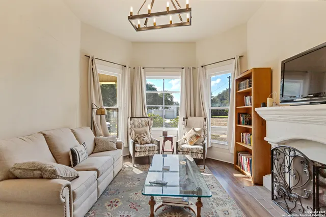a living room with furniture a fireplace and a flat screen tv