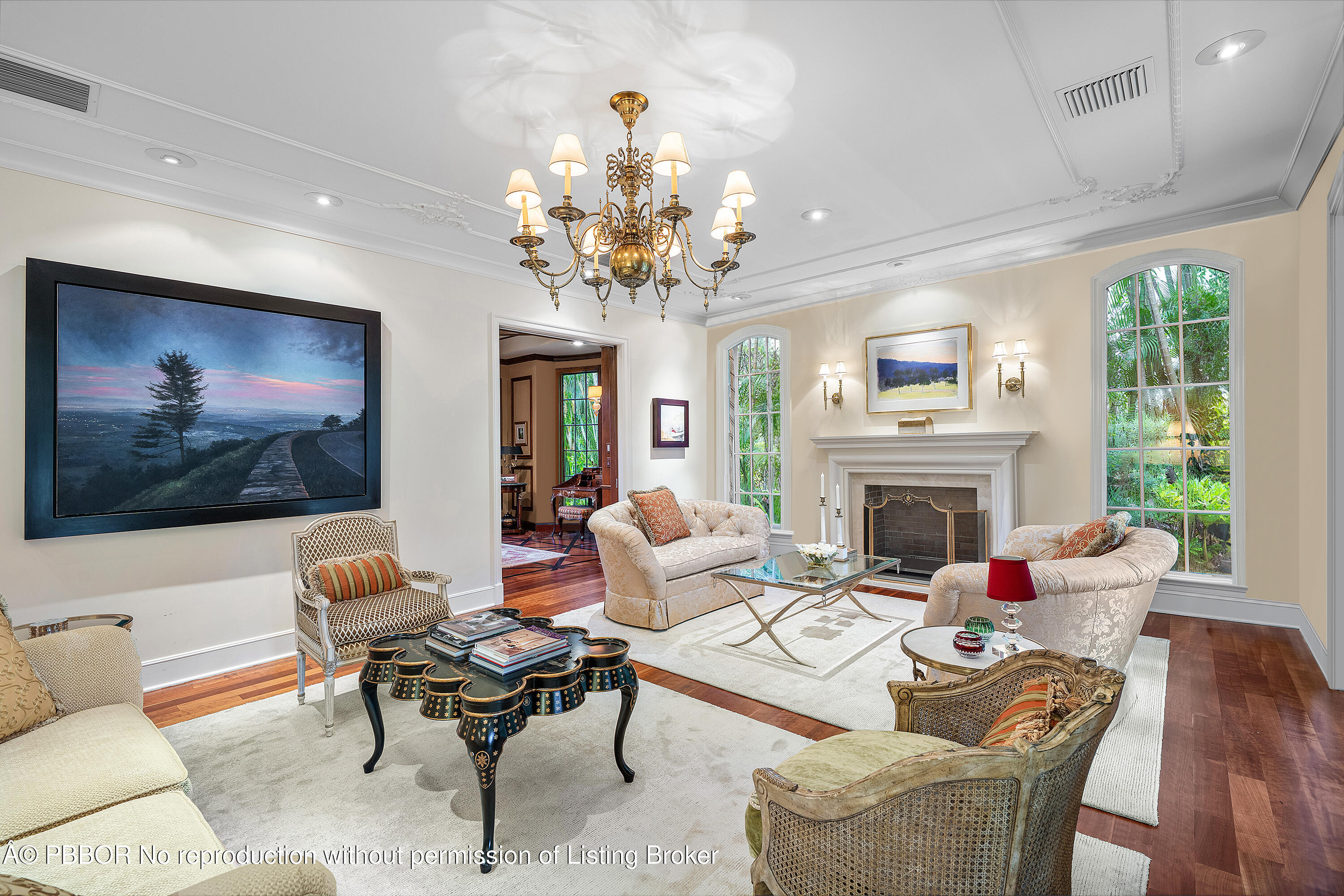 242 Wells Road Palm Beach, FL 33480 - Photo 10 of 54 a living room with furniture a chandelier and a fireplace