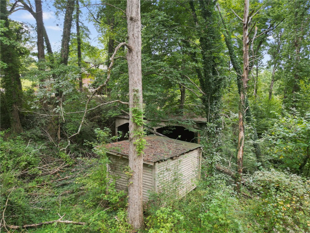 133 Pinetree Lane Easley, SC 29640 - Photo 10 of 28 Mature trees surround rustic outbuildings tucked away in a quiet wooded setting.
