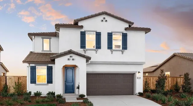 a front view of a house with garage