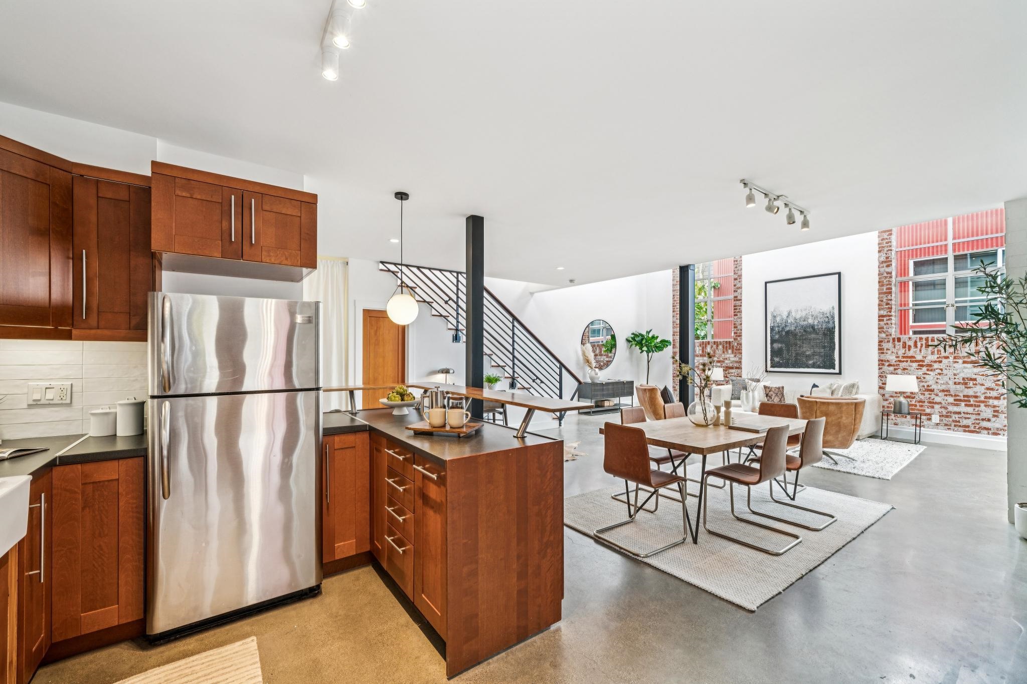 829 21st Street, Unit 3 Oakland, CA 94607 - Photo 47 of 47 Kitchen with track lighting, freestanding refrigerator, concrete floors, open floor plan, and wood finish cabinets