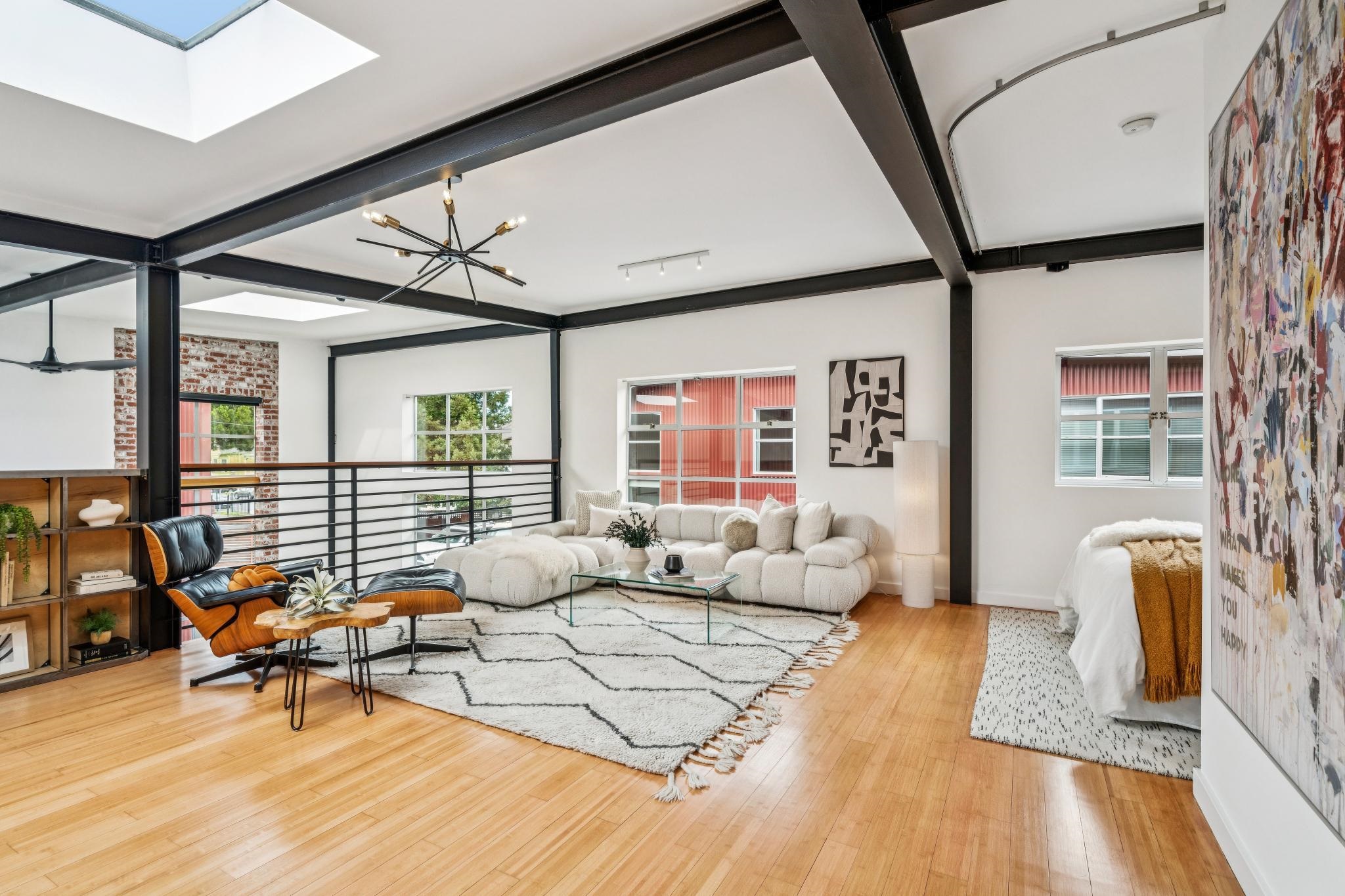 829 21st Street, Unit 3 Oakland, CA 94607 - Photo 22 of 47 Living room featuring light wood finished floors, beamed ceiling, a chandelier, plenty of natural light, and a skylight