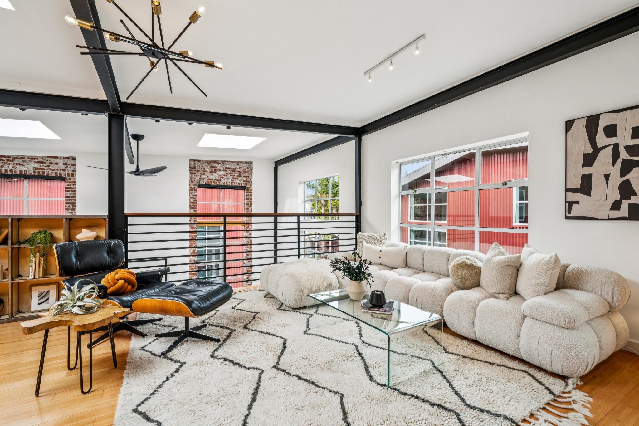 829 21st Street, Unit 3 Oakland, CA 94607 - Photo 23 of 47 Living room featuring light wood-style floors, a skylight, and hanging lights