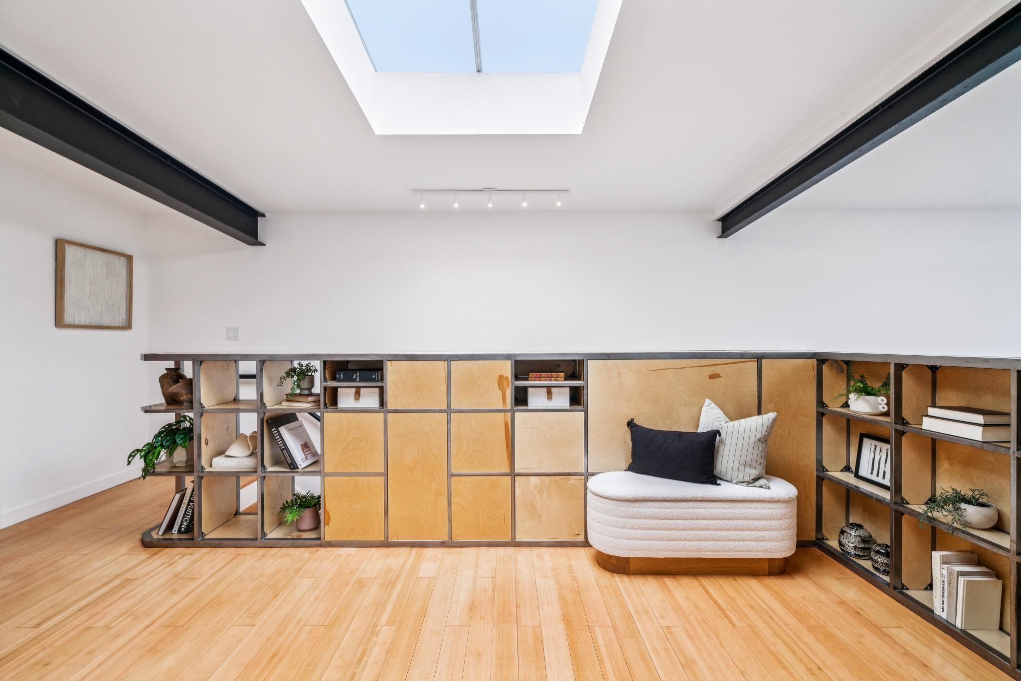 829 21st Street, Unit 3 Oakland, CA 94607 - Photo 25 of 47 Living area with beamed ceiling, wood finished floors, and a skylight