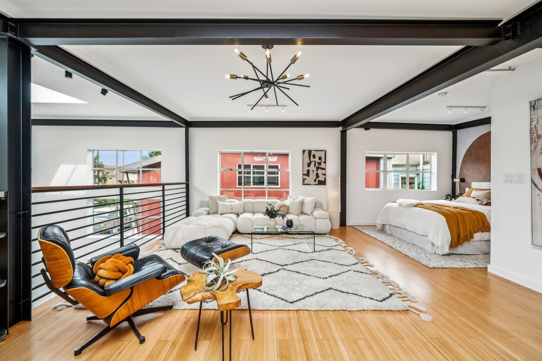 829 21st Street, Unit 3 Oakland, CA 94607 - Photo 29 of 47 Living area featuring light wood-style floors, suspended lighting, and beam ceiling
