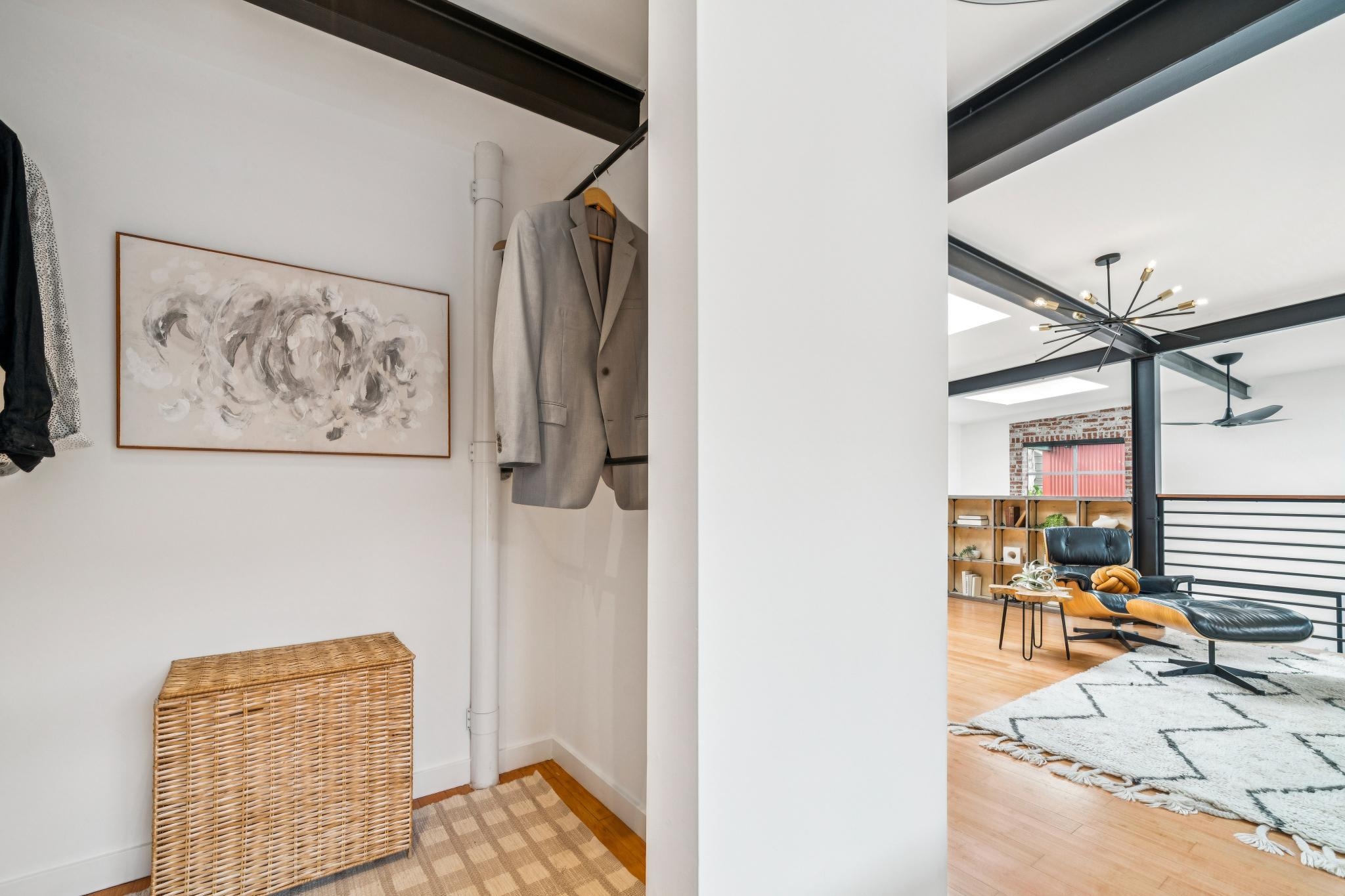 829 21st Street, Unit 3 Oakland, CA 94607 - Photo 31 of 47 Detailed view of wood finished floors, beam ceiling, and a chandelier