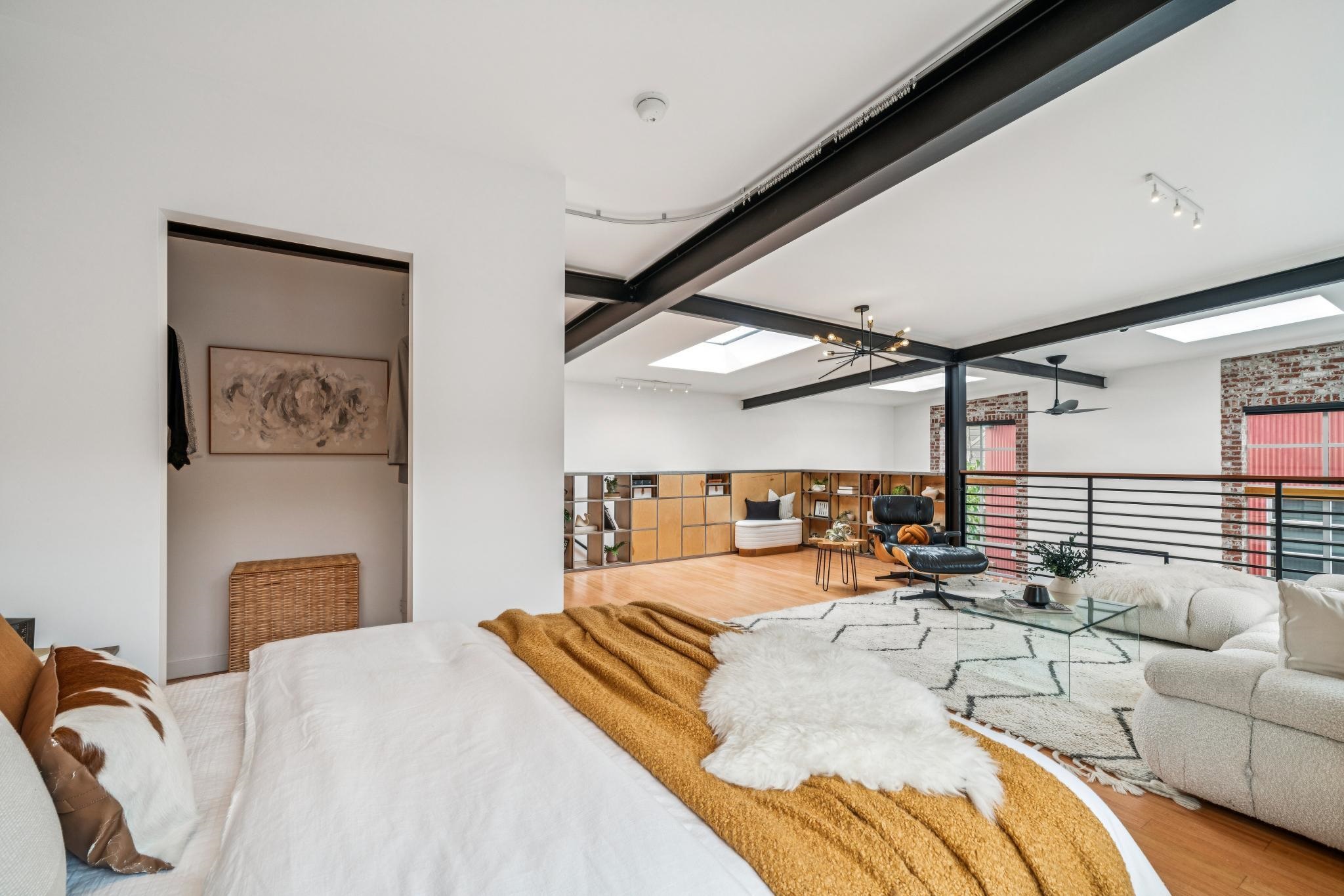 829 21st Street, Unit 3 Oakland, CA 94607 - Photo 32 of 47 Bedroom with wood finished floors, beam ceiling, a skylight, and a wood stove
