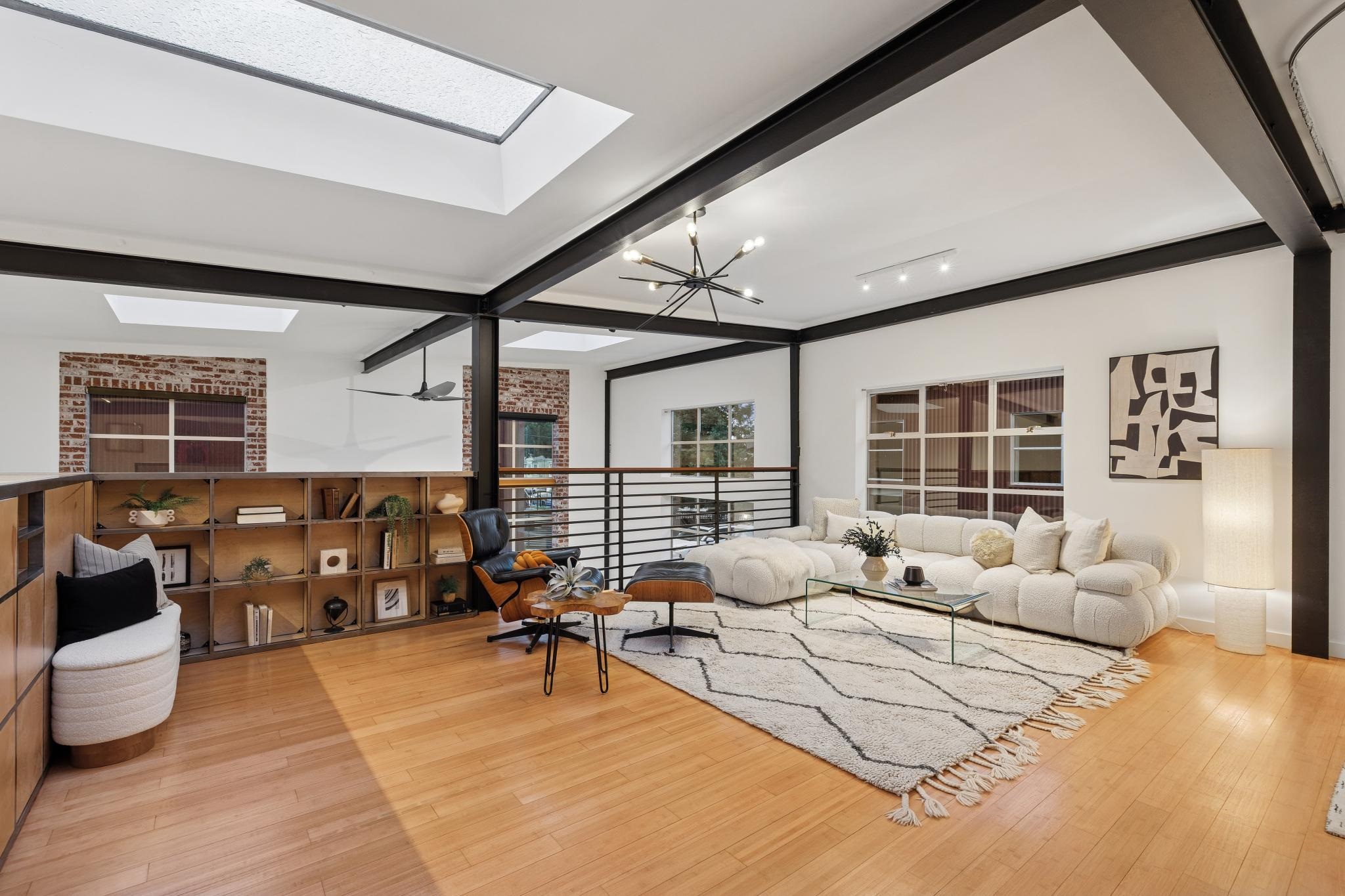 829 21st Street, Unit 3 Oakland, CA 94607 - Photo 34 of 47 Living area featuring light wood-style floors, beam ceiling, suspended lighting, and a skylight