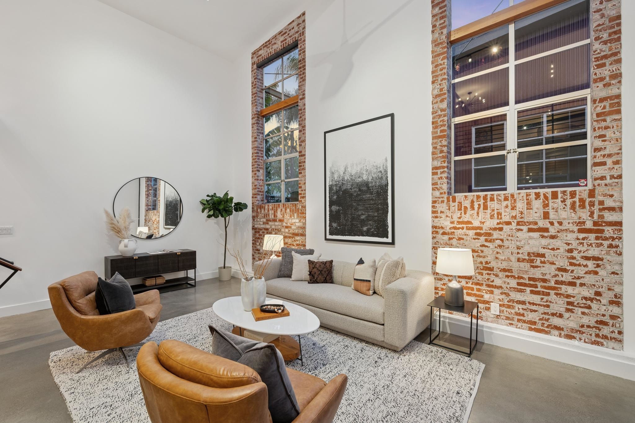829 21st Street, Unit 3 Oakland, CA 94607 - Photo 39 of 47 Living room with a high ceiling, finished concrete flooring, and brick wall